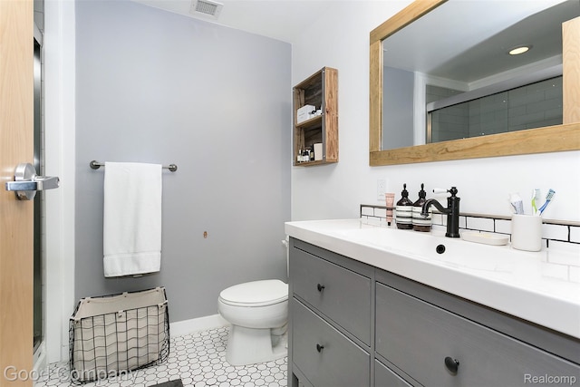 55 W Canfield Unit 210, Detroit, MI 48201 - bathroom featuring vanity, toilet, a shower with door, and baseboards