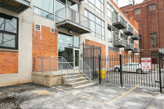 55 W Canfield Unit 210, Detroit, MI 48201 - doorway to property with uncovered parking and brick siding