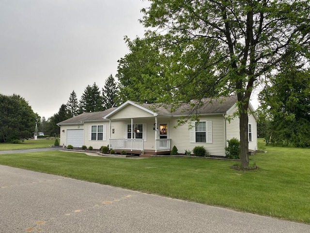 10439 Castaway Ct, Canadian Lakes, MI 49346 - ranch-style house featuring covered porch, an attached garage, asphalt driveway, and a front lawn