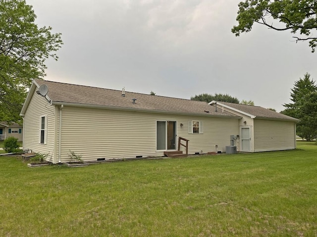 10439 Castaway Ct, Canadian Lakes, MI 49346 - back of property with entry steps, a yard, and central AC unit