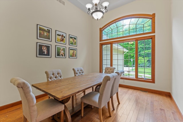 11082 Hoffman Rd, Marcellus, MI 49067 - dining space with baseboards, light wood-style flooring, and a chandelier