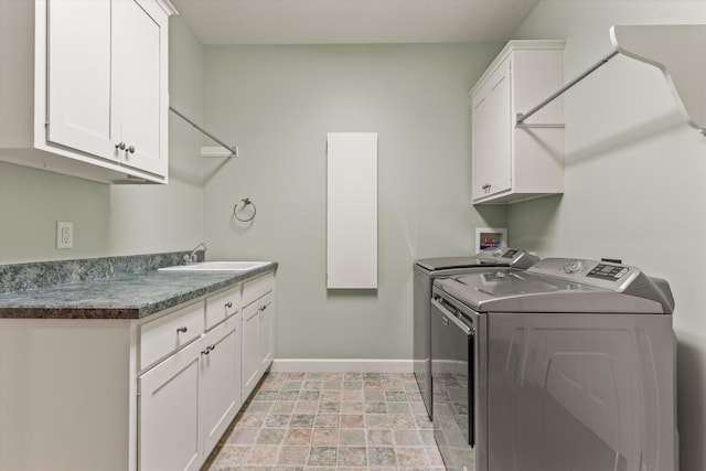 11082 Hoffman Rd, Marcellus, MI 49067 - laundry area featuring baseboards, independent washer and dryer, and cabinet space