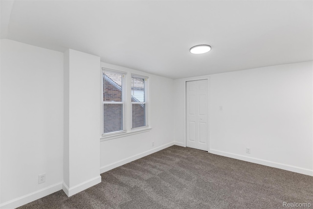 7505 E Robinwood St, Detroit, MI 48234 - spare room featuring dark carpet and baseboards