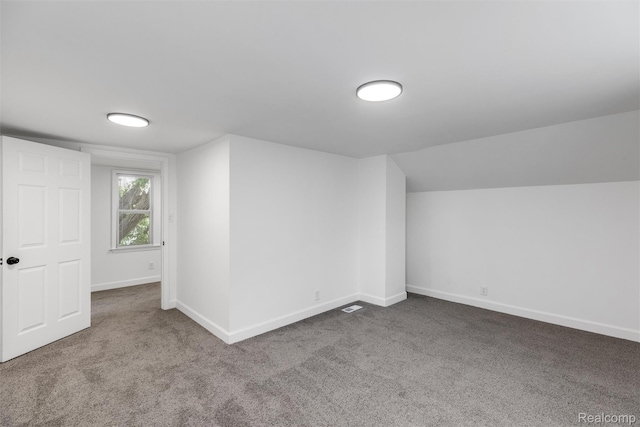 7505 E Robinwood St, Detroit, MI 48234 - additional living space with carpet flooring, baseboards, and vaulted ceiling