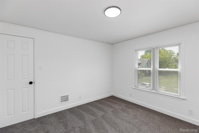 7505 E Robinwood St, Detroit, MI 48234 - empty room with dark carpet, baseboards, and crown molding