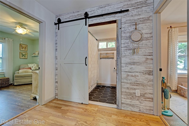 110 Minnetonka Dr, Oxford, MI 48371 - entryway with a ceiling fan, a barn door, wood finished floors, and healthy amount of natural light