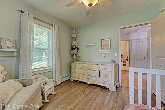 110 Minnetonka Dr, Oxford, MI 48371 - bedroom with wood finished floors, baseboard heating, a ceiling fan, and attic access