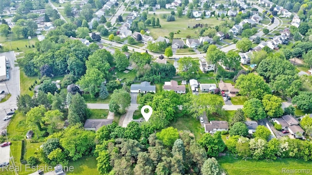 110 Minnetonka Dr, Oxford, MI 48371 - aerial overview of property's location with a tree filled landscape and nearby suburban area