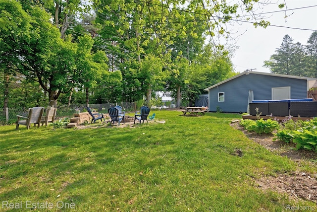 110 Minnetonka Dr, Oxford, MI 48371 - view of yard featuring an outdoor fire pit and view of wooded area