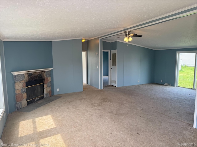 59227 Lewis Ln, New Haven, MI 48048 - unfurnished living room featuring a ceiling fan, crown molding, a fireplace, carpet floors, and a textured ceiling
