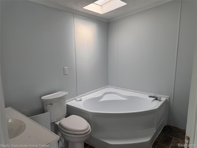 59227 Lewis Ln, New Haven, MI 48048 - bathroom featuring a skylight, a garden tub, a textured ceiling, vanity, and stone finish floors