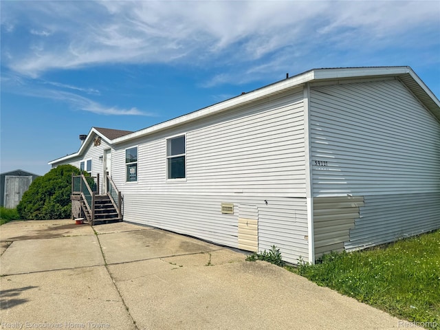 59227 Lewis Ln, New Haven, MI 48048 - view of side of home with a patio area