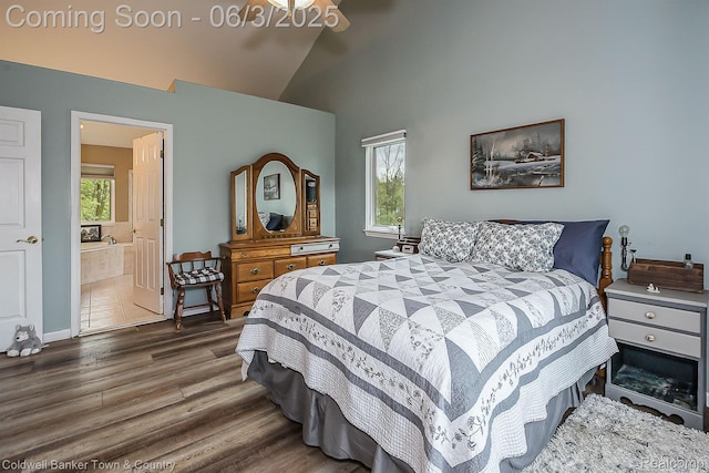 1355 Maxfield Rd, Brighton, MI 48114 - bedroom with wood finished floors, multiple windows, high vaulted ceiling, ensuite bathroom, and baseboards