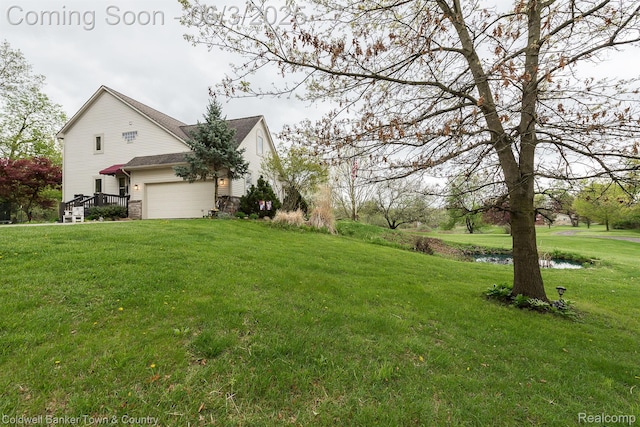 1355 Maxfield Rd, Brighton, MI 48114 - view of green lawn with an attached garage