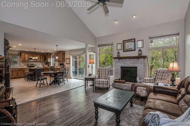 1355 Maxfield Rd, Brighton, MI 48114 - living area featuring ceiling fan, high vaulted ceiling, recessed lighting, a fireplace, and light wood-type flooring