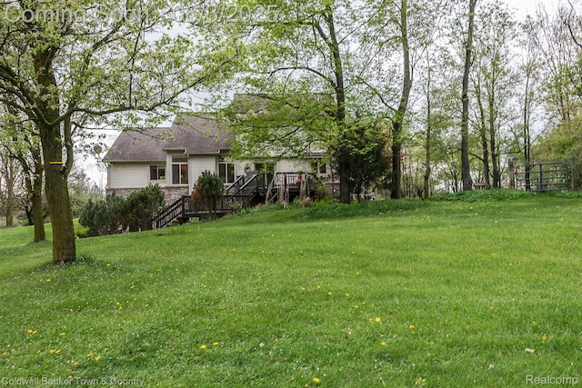 1355 Maxfield Rd, Brighton, MI 48114 - view of grassy yard with stairway and a deck