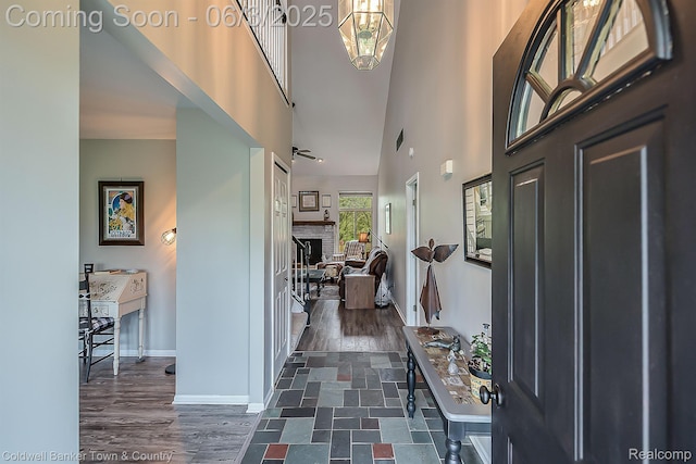 1355 Maxfield Rd, Brighton, MI 48114 - foyer with a towering ceiling, baseboards, dark wood-type flooring, and a fireplace
