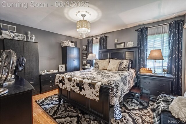 527 Montana St, Marysville, MI 48040 - bedroom featuring a chandelier and light wood-type flooring