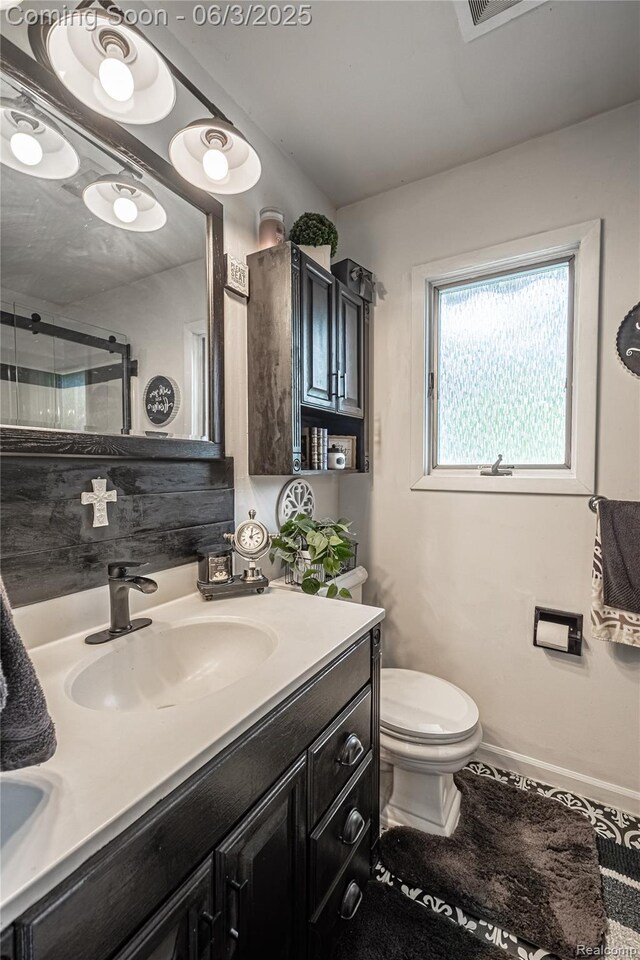 527 Montana St, Marysville, MI 48040 - bathroom with vanity, toilet, a shower with door, and baseboards