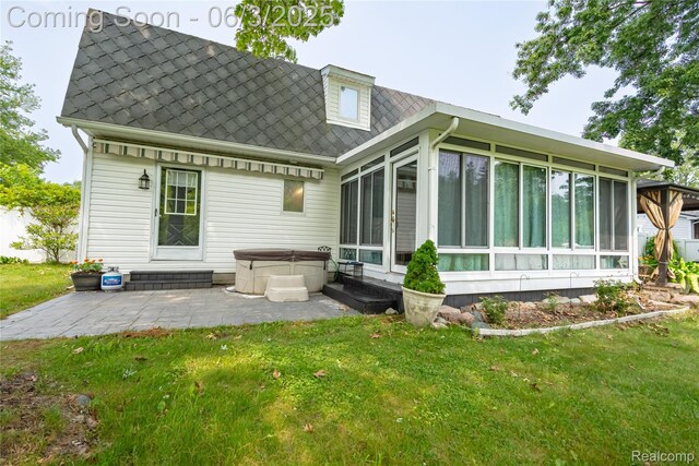 527 Montana St, Marysville, MI 48040 - back of property featuring a hot tub, a sunroom, a patio area, and a lawn