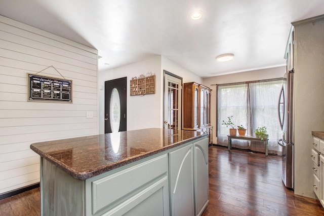 2278 W Wagner Rd, Buchanan, MI 49107 - kitchen with dark wood-style flooring, wood walls, dark stone countertops, gray cabinets, and a kitchen island
