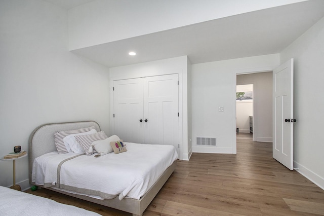121 S Barker St, New Buffalo, MI 49117 - bedroom featuring light wood-style floors, baseboards, recessed lighting, and a closet