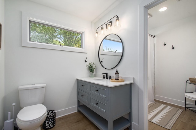 121 S Barker St, New Buffalo, MI 49117 - full bath with vanity, wood finished floors, toilet, baseboards, and curtained shower