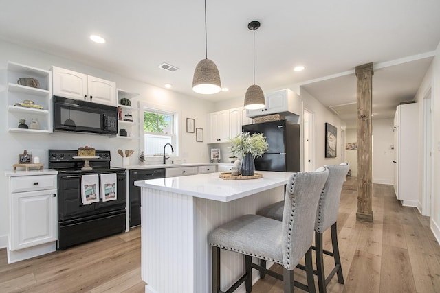 121 S Barker St, New Buffalo, MI 49117 - kitchen featuring black appliances, open shelves, white cabinetry, a breakfast bar area, and recessed lighting