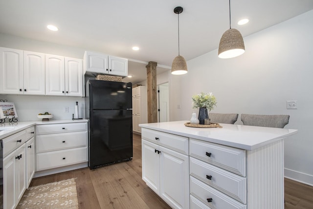 121 S Barker St, New Buffalo, MI 49117 - kitchen featuring freestanding refrigerator, light wood-style floors, white cabinetry, pendant lighting, and light countertops