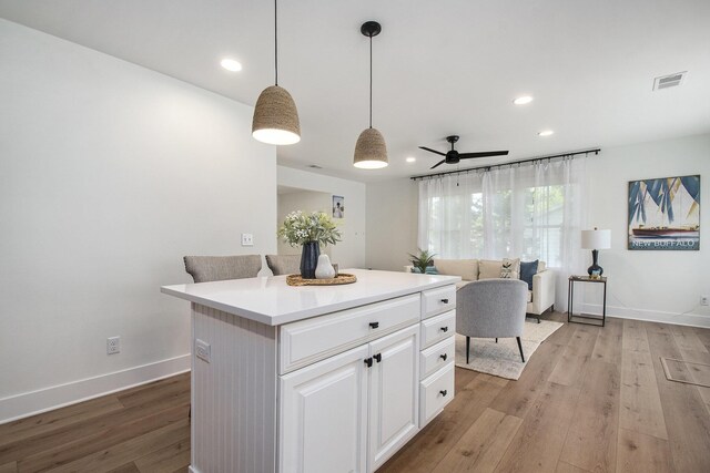 121 S Barker St, New Buffalo, MI 49117 - kitchen featuring light wood-style floors, white cabinetry, a ceiling fan, recessed lighting, and light countertops