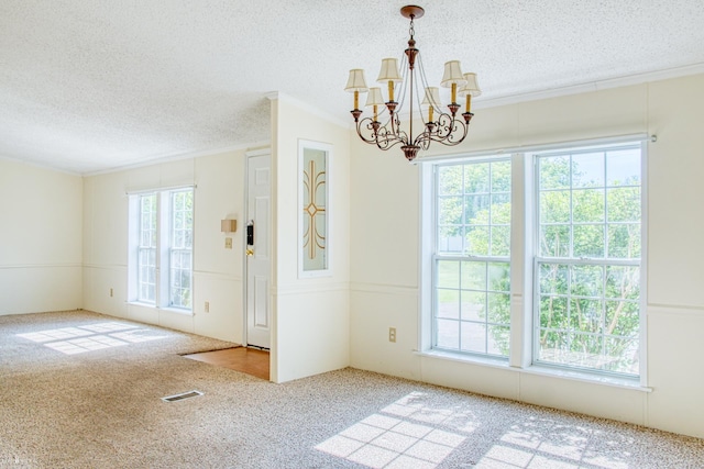 3490 Luce Rd, Flushing, MI 48433 - carpeted spare room with crown molding, a textured ceiling, and a chandelier