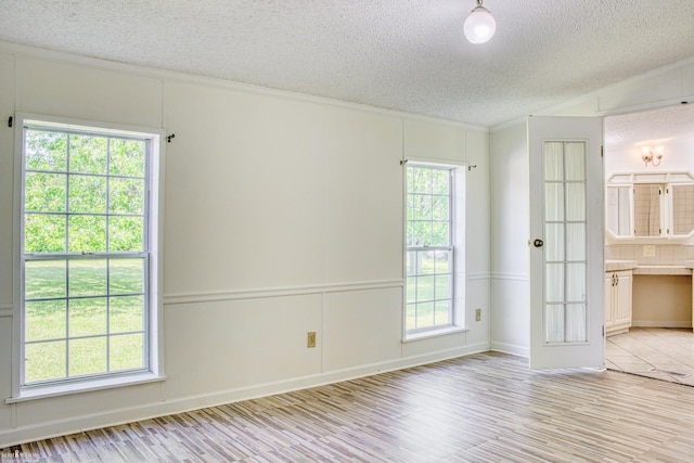 3490 Luce Rd, Flushing, MI 48433 - unfurnished room with a textured ceiling, light wood finished floors, and ornamental molding