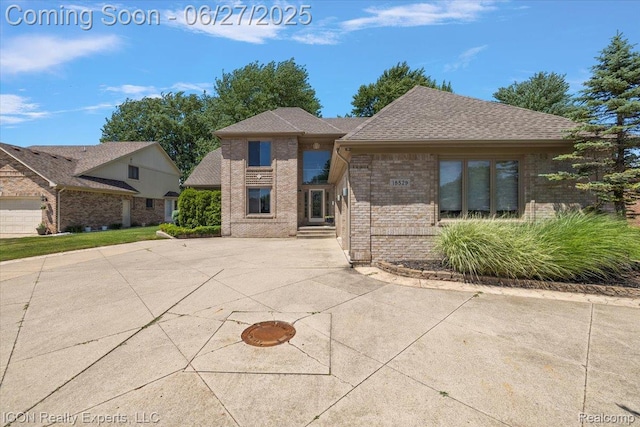18529 Sumpter Forest Dr, Macomb, MI 48042 - view of front facade featuring brick siding and roof with shingles