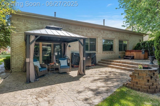 18529 Sumpter Forest Dr, Macomb, MI 48042 - rear view of house with a hot tub, a gazebo, brick siding, and a patio