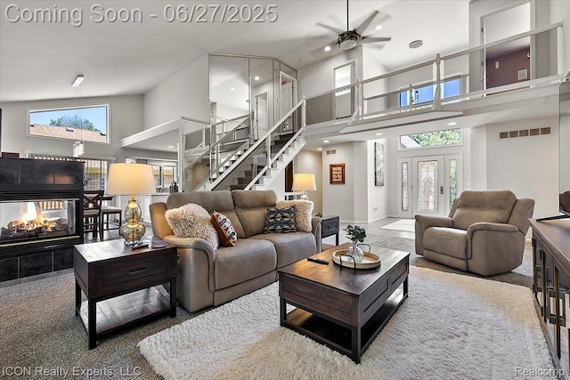 18529 Sumpter Forest Dr, Macomb, MI 48042 - living area with a towering ceiling, ceiling fan, stairway, a tiled fireplace, and recessed lighting