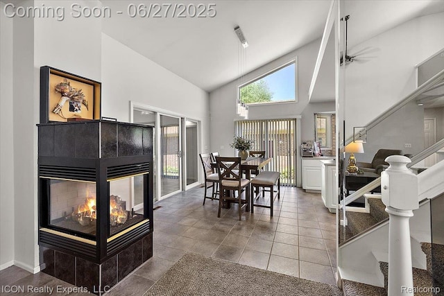 18529 Sumpter Forest Dr, Macomb, MI 48042 - dining room with high vaulted ceiling, stairs, and a tiled fireplace