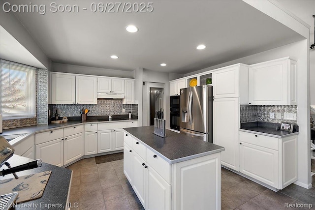 18529 Sumpter Forest Dr, Macomb, MI 48042 - kitchen with black appliances, under cabinet range hood, dark countertops, tasteful backsplash, and recessed lighting