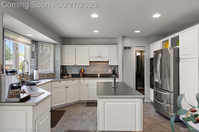 18529 Sumpter Forest Dr, Macomb, MI 48042 - kitchen featuring stainless steel fridge with ice dispenser, recessed lighting, a kitchen island, backsplash, and white cabinetry