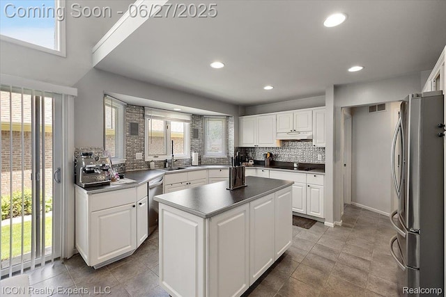 18529 Sumpter Forest Dr, Macomb, MI 48042 - kitchen with appliances with stainless steel finishes, tasteful backsplash, healthy amount of natural light, white cabinets, and recessed lighting