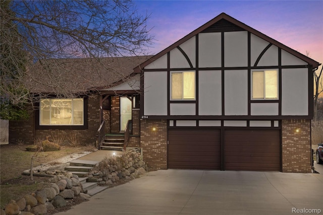 254 Cross Timbers St, Oxford, MI 48371 - view of front of home featuring brick siding, driveway, a garage, and stucco siding