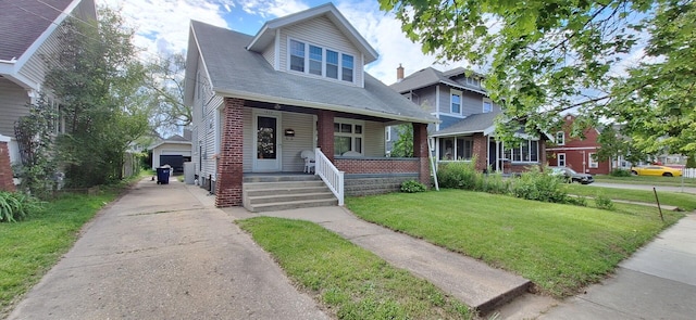 1907 Darwin Ave SW, Grand Rapids, MI 49507 - bungalow-style home featuring a porch, a front yard, brick siding, and an outdoor structure