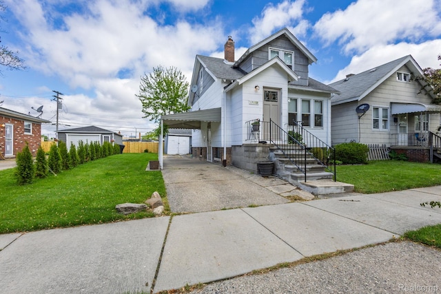 17173 New York St, Detroit, MI 48224 - view of front of home featuring a chimney, driveway, a shingled roof, a garage, and an outbuilding