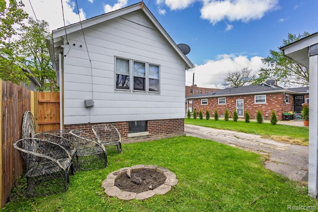 17173 New York St, Detroit, MI 48224 - view of property exterior with an outdoor fire pit