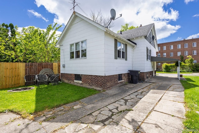 17173 New York St, Detroit, MI 48224 - back of property featuring a shingled roof and concrete driveway