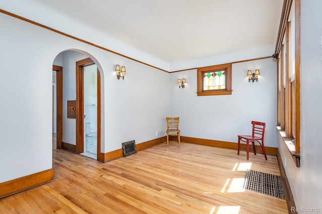 17173 New York St, Detroit, MI 48224 - spare room featuring light wood-style floors, arched walkways, and baseboards