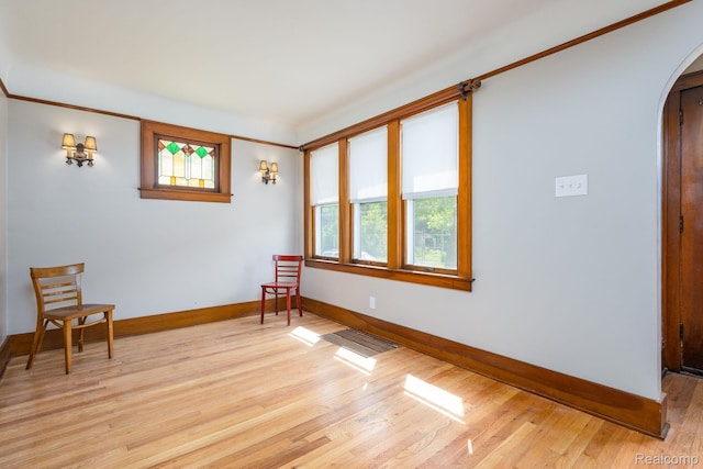 17173 New York St, Detroit, MI 48224 - sitting room featuring arched walkways, baseboards, and light wood-style flooring
