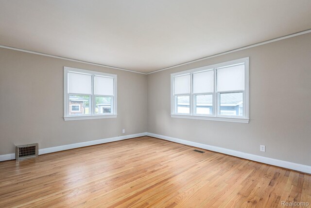 17173 New York St, Detroit, MI 48224 - unfurnished room with baseboards, light wood-style flooring, and ornamental molding