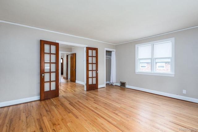 17173 New York St, Detroit, MI 48224 - spare room with french doors, light wood-style floors, baseboards, and crown molding