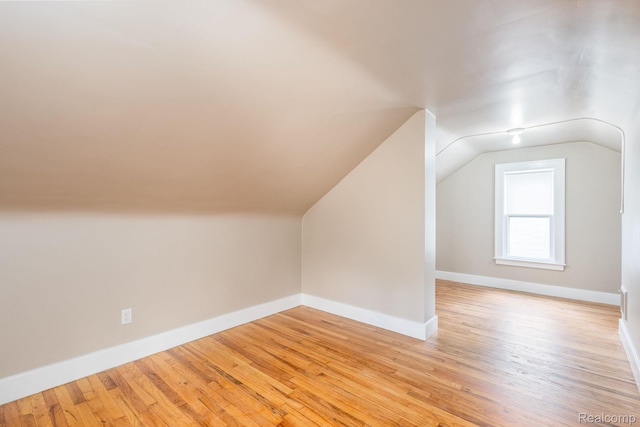 17173 New York St, Detroit, MI 48224 - additional living space with vaulted ceiling, light wood-type flooring, and baseboards