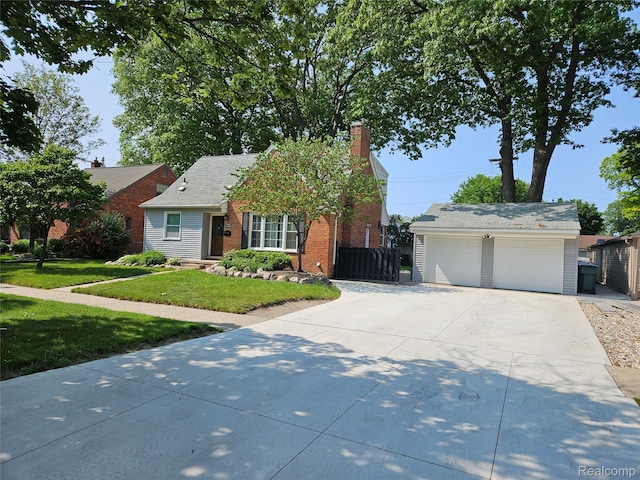 24934 Wilson Ave S, Dearborn, MI 48128 - view of front of home with brick siding, a chimney, a detached garage, and an outbuilding